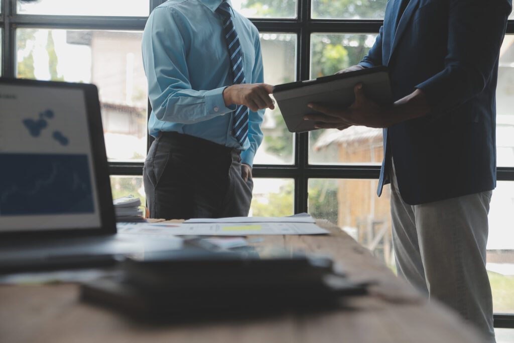 A man in a suit using his tablet to show MSSP advantages to a business owner