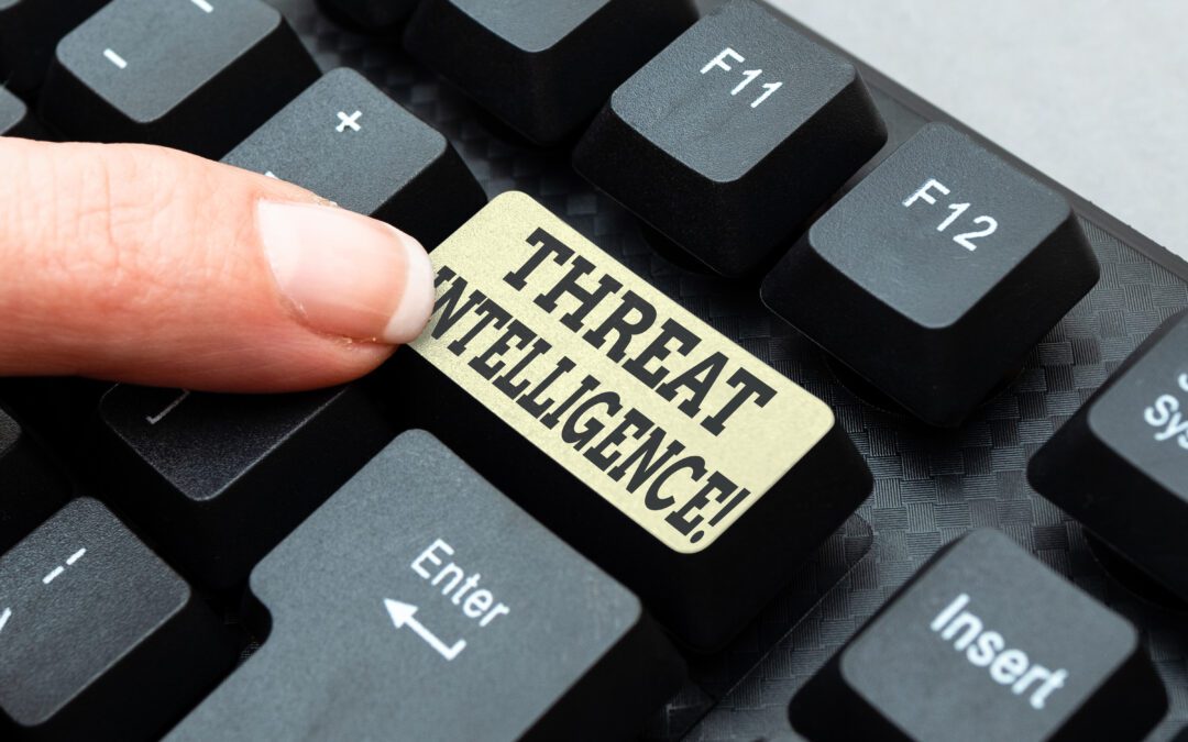 A finger touches a threat intelligence button that’s above the enter button on a keyboard.